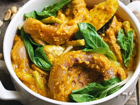 Kare-kare is a Philippine stew complemented with a thick savory peanut sauce. It is made from a variation base of stewed oxtail, pork hocks, calves fe...